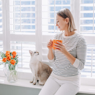 Beautiful,Happy,Middle,Age,Woman,Sitting,On,Windowsill,At,Home